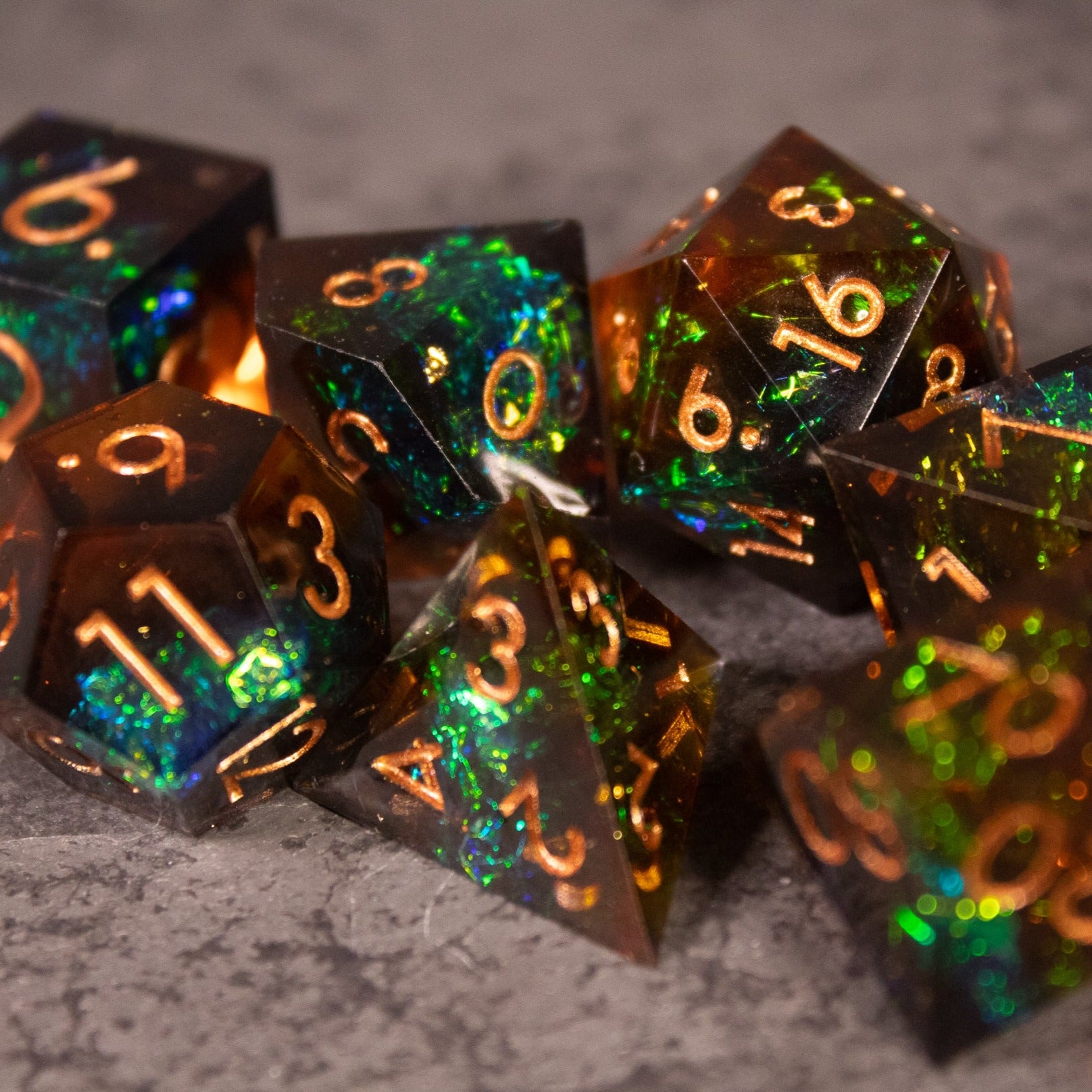 Whiskeyjack Dice Set - Glossy multi-colored sharp edge polyhedral dice with glowing orange numbers.