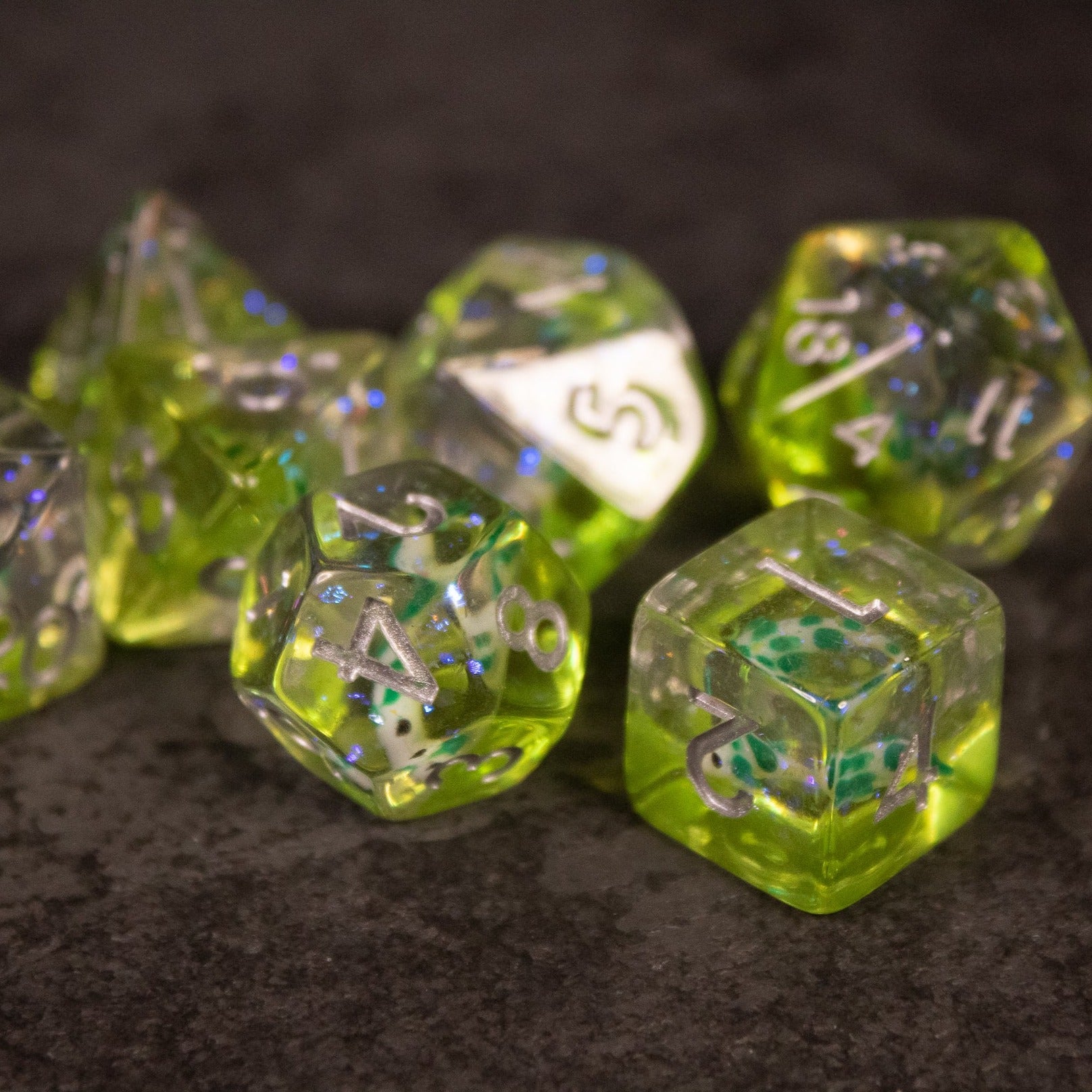 Green Koi Fish Dice Set - Set of translucent green polyhedral dice with embedded miniature koi fish inclusions and white numbering.