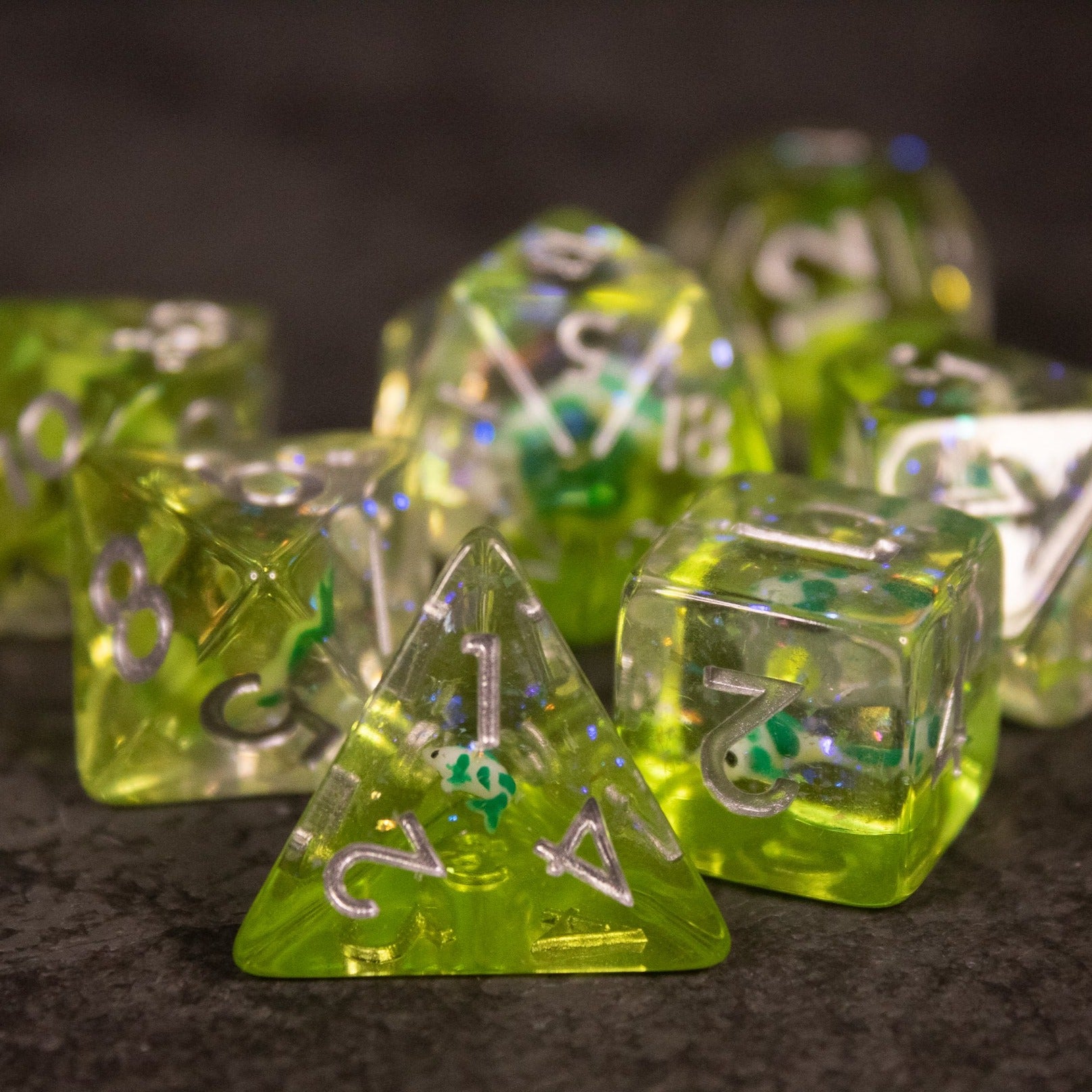 Green Koi Fish Dice Set - Translucent green polyhedral dice set with embedded koi fish designs and white numbering.