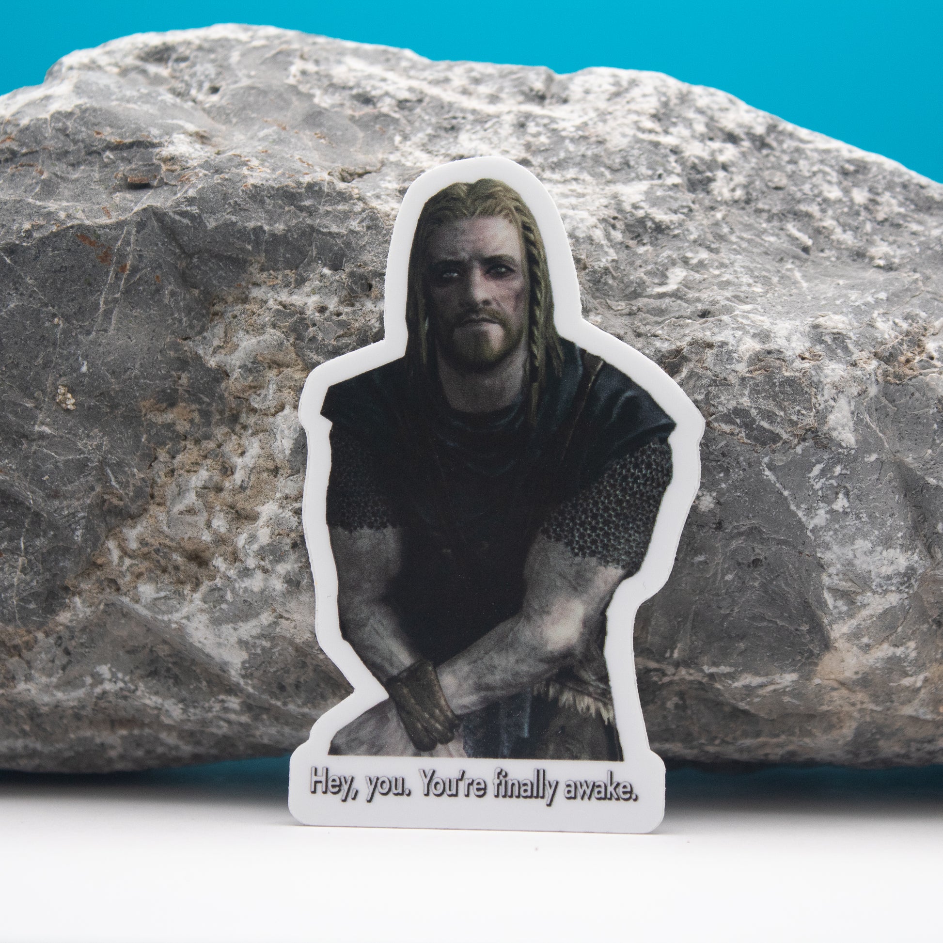 Hey, you. You're Finally Awake. - Skyrim character kneeling with long hair and beard, text "Hey, you. You're finally awake." sticker.