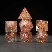 Pink Flower Sharp Edge Dice Set - Clear pink sharp edge dice set with embedded flower petals and gold numbers on a black background.