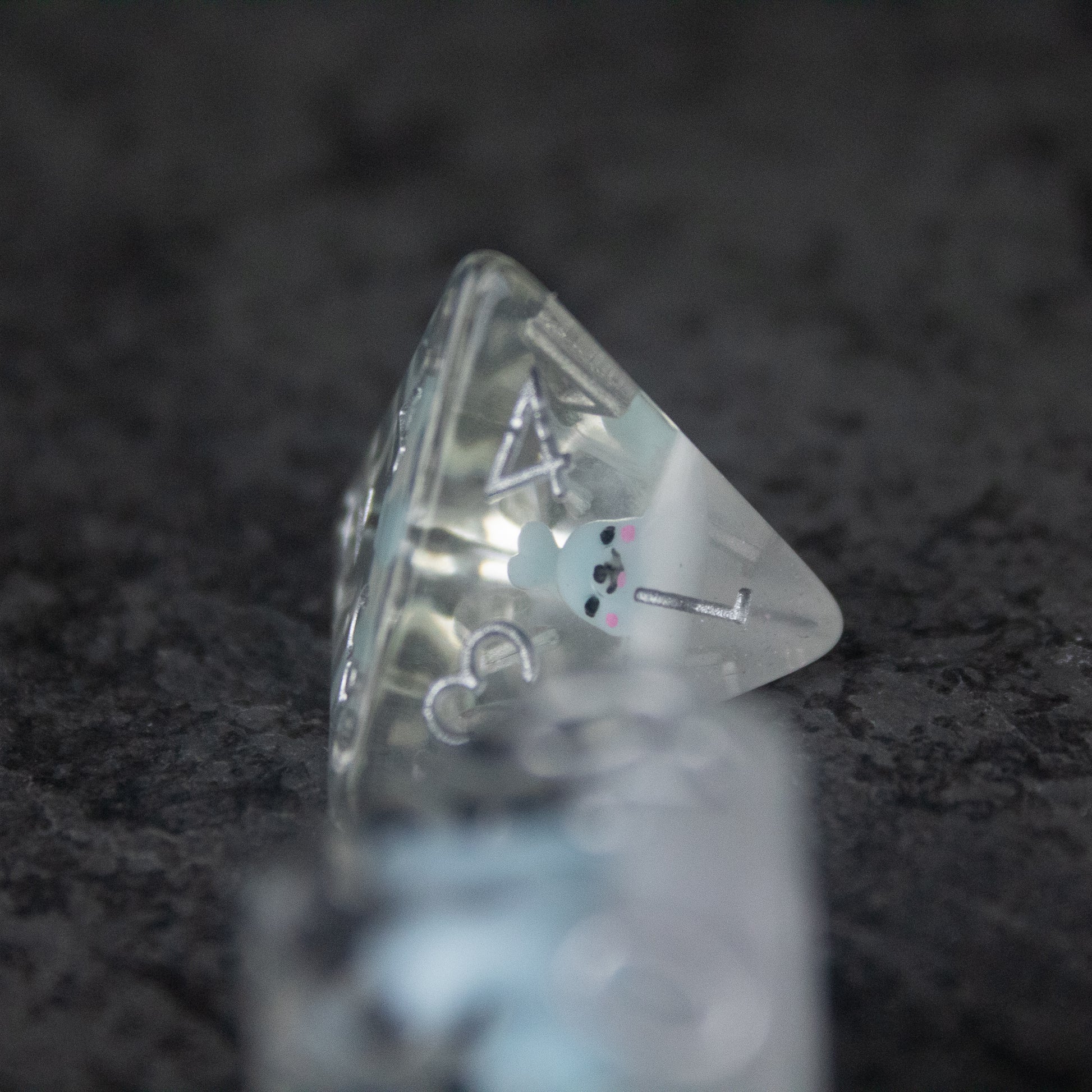 Blue Seal Dice Set - Translucent blue four-sided dice with white numbers and a small seal illustration on one face.