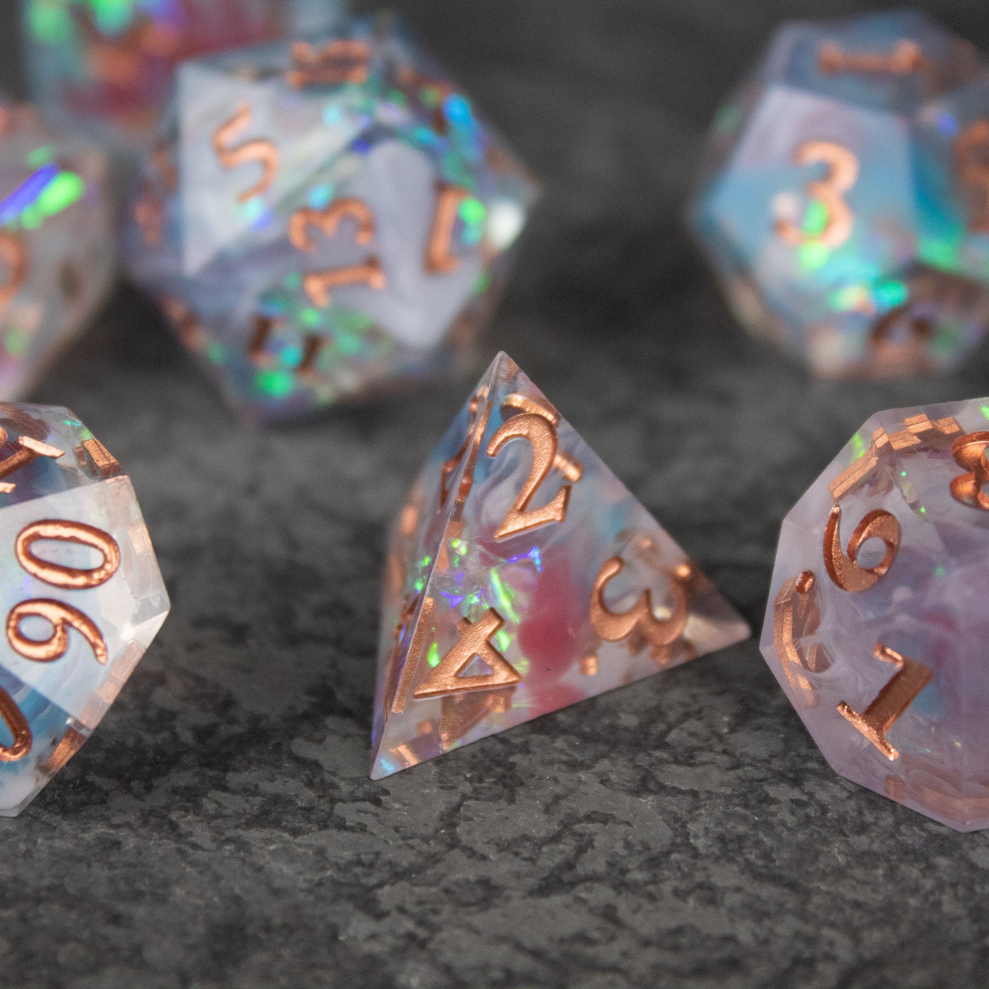 Divination Dice Set - Transparent polyhedral dice set with sharp edges, copper numbers, and iridescent glitter inside.