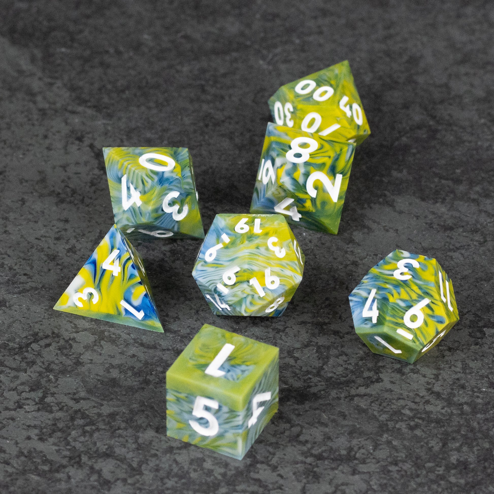 Acid Splash Dice Set - Set of six sharp-edged polyhedral dice with green and yellow marbled design and white numbers.
