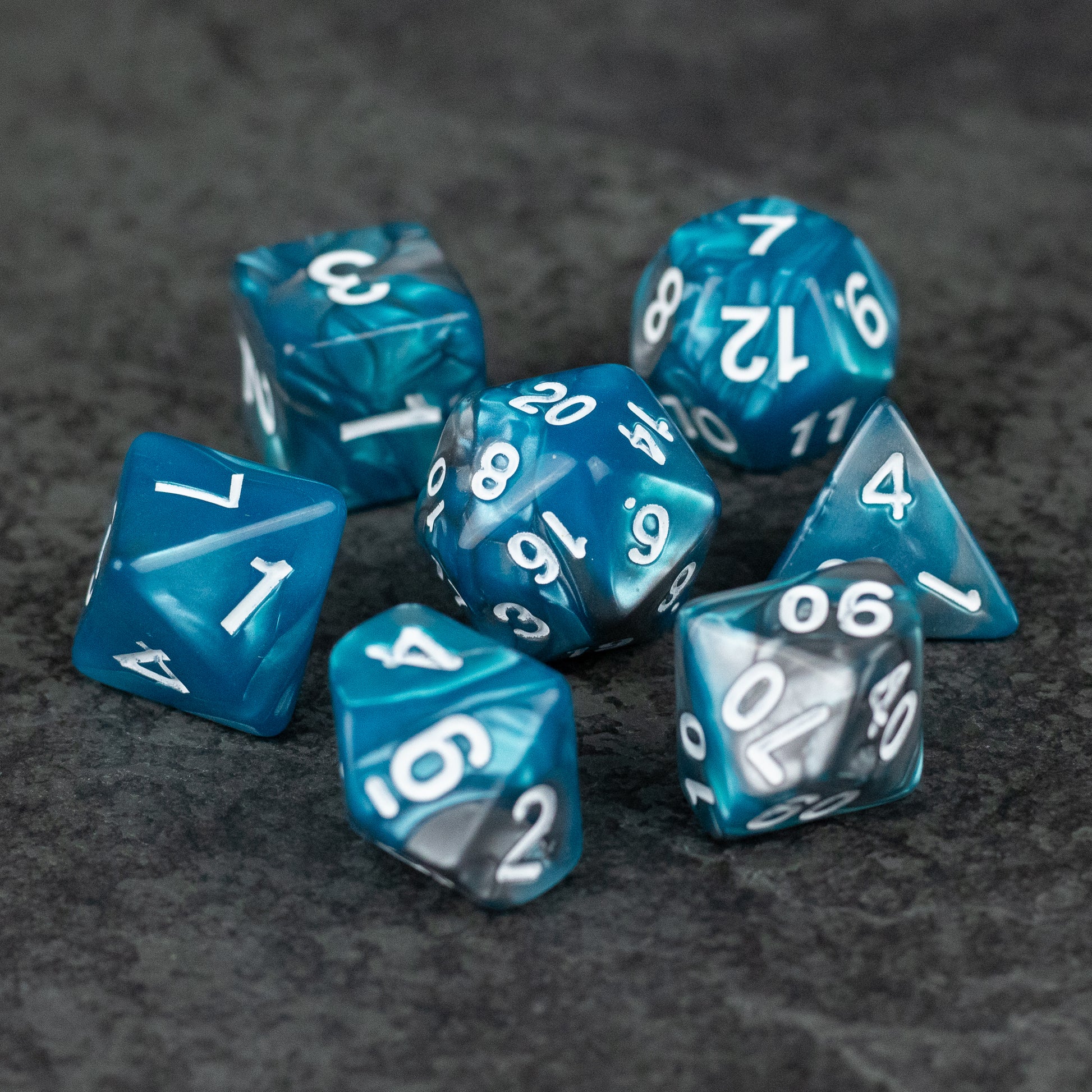 Blue and Gray Marbled Dice - Set of seven blue and gray marbled acrylic dice with white numbers on gray background.