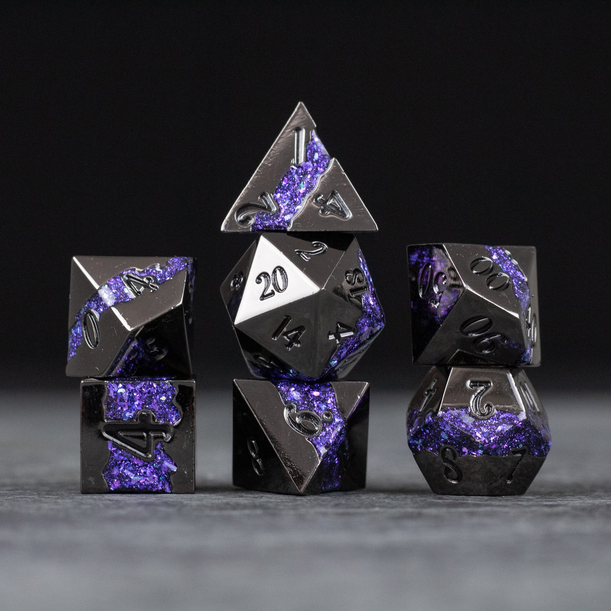 Purple Rift Dice Set - Metal purple and black seven-piece RPG dice set with crystalline textures and silver numbering.