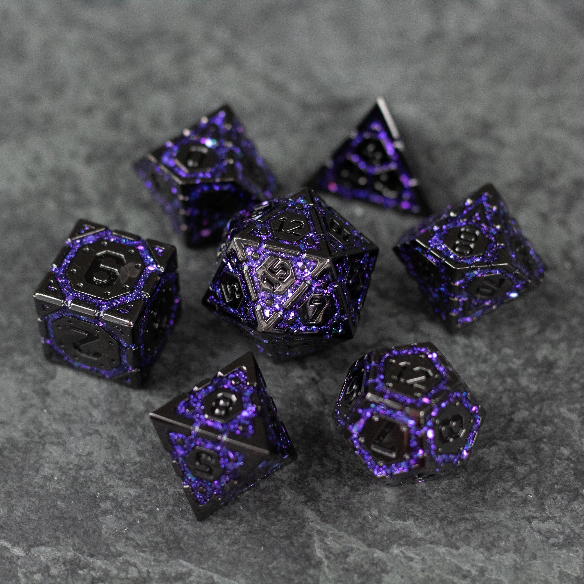Purple Arcane Ward Dice Set - Metallic black and purple arcane-themed seven-piece dice set on gray stone surface.