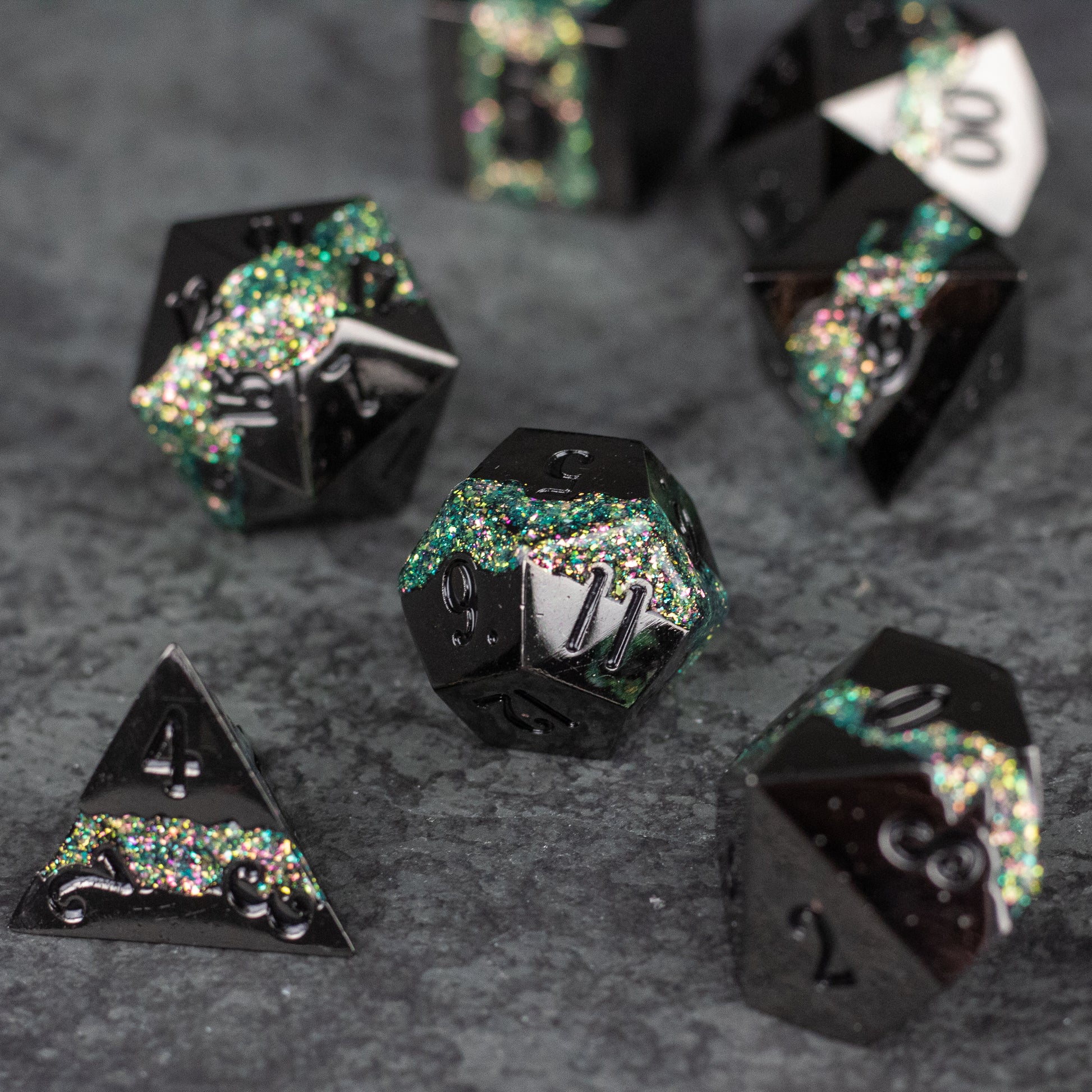 Light Green Rift Dice Set - Black metal dice with light green and silver glitter embedded, seven-piece set on dark surface.