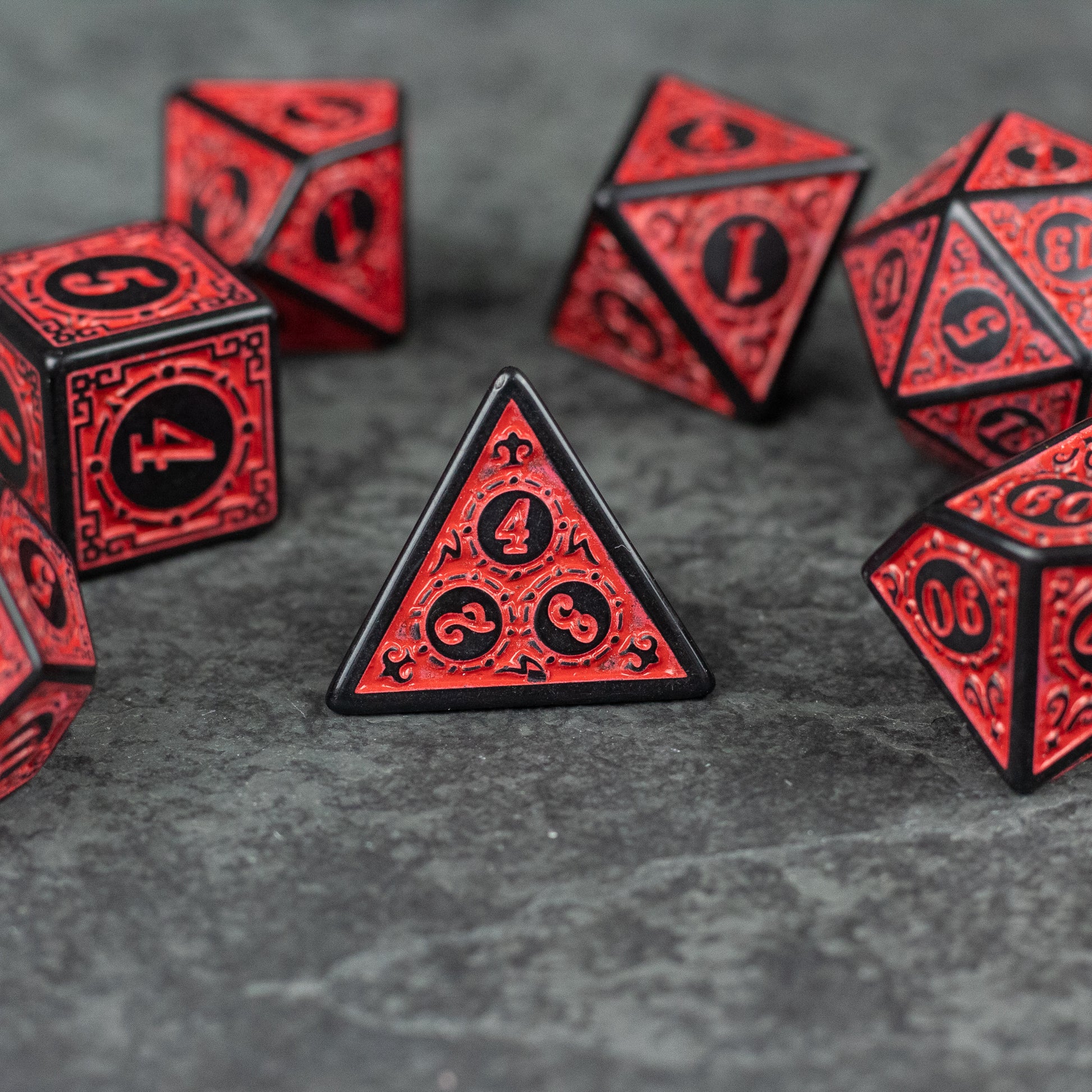 Red Runes Acrylic Dice Set - Red acrylic dice set with black-outlined intricate runes and numbers, various polyhedral shapes.