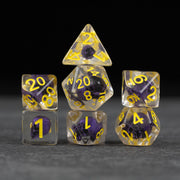 Purple Skull Dice Set - Seven transparent dice with embedded purple skulls and yellow numbering arranged in a pyramid shape on black background.