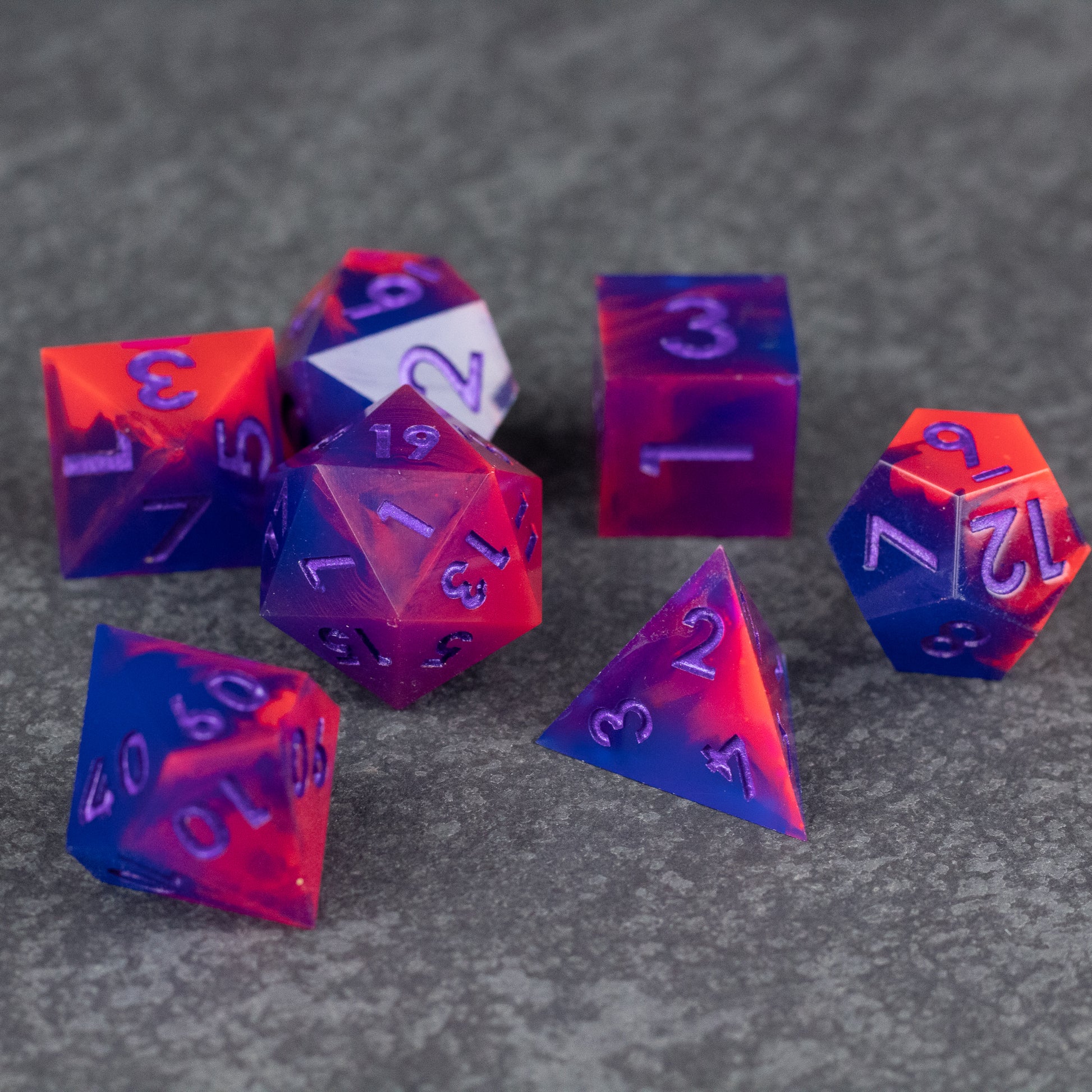 Outrun Dice Set - Set of seven sharp-edged polyhedral dice in vibrant neon orange and purple with white numbering.