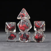 Red Skull Dice Set - Clear polyhedral dice set with red skull inclusions and black numbers on each face.