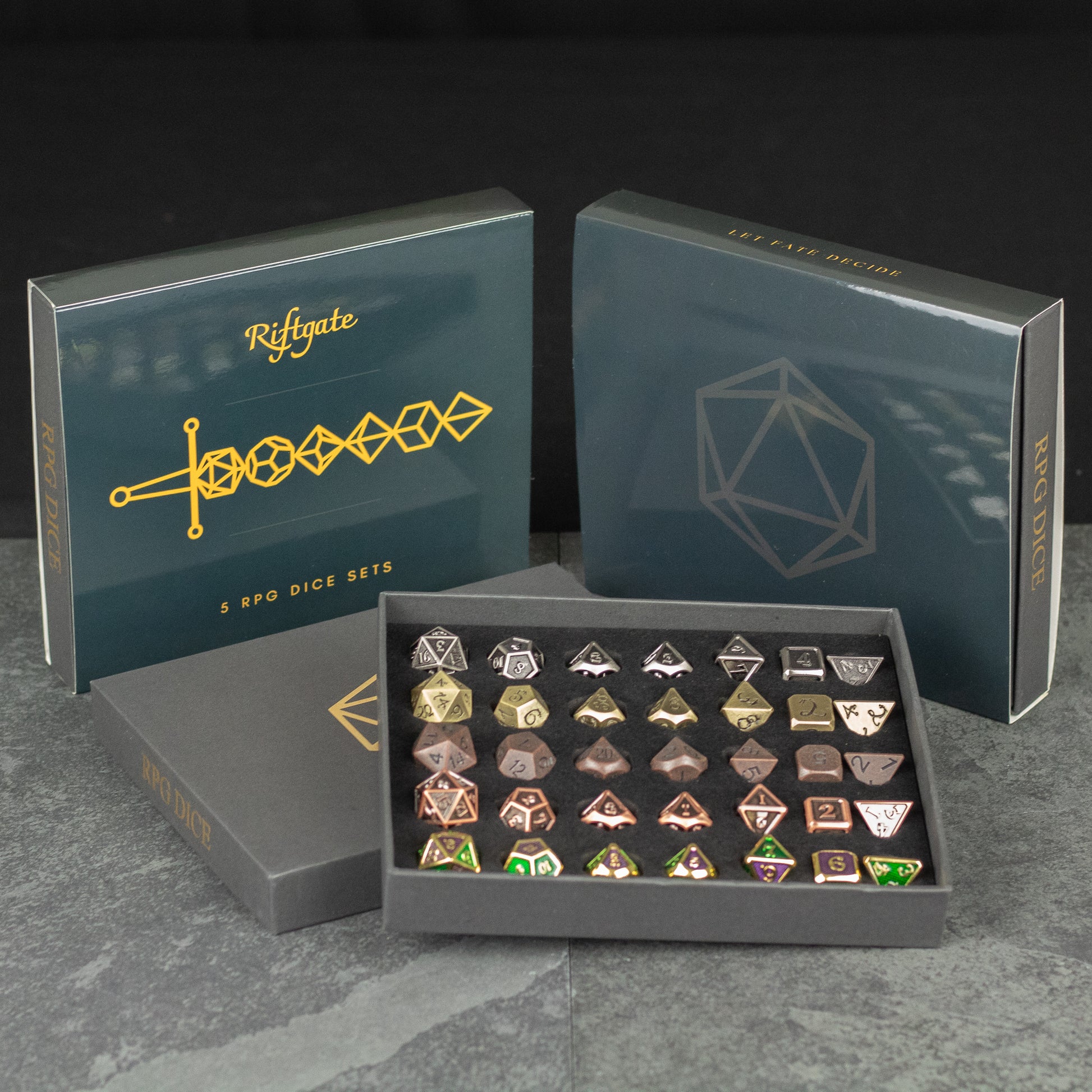 Metal Dice Set Gift Box - Metal polyhedral dice set in black gift box with gold geometric designs and logo on lids.