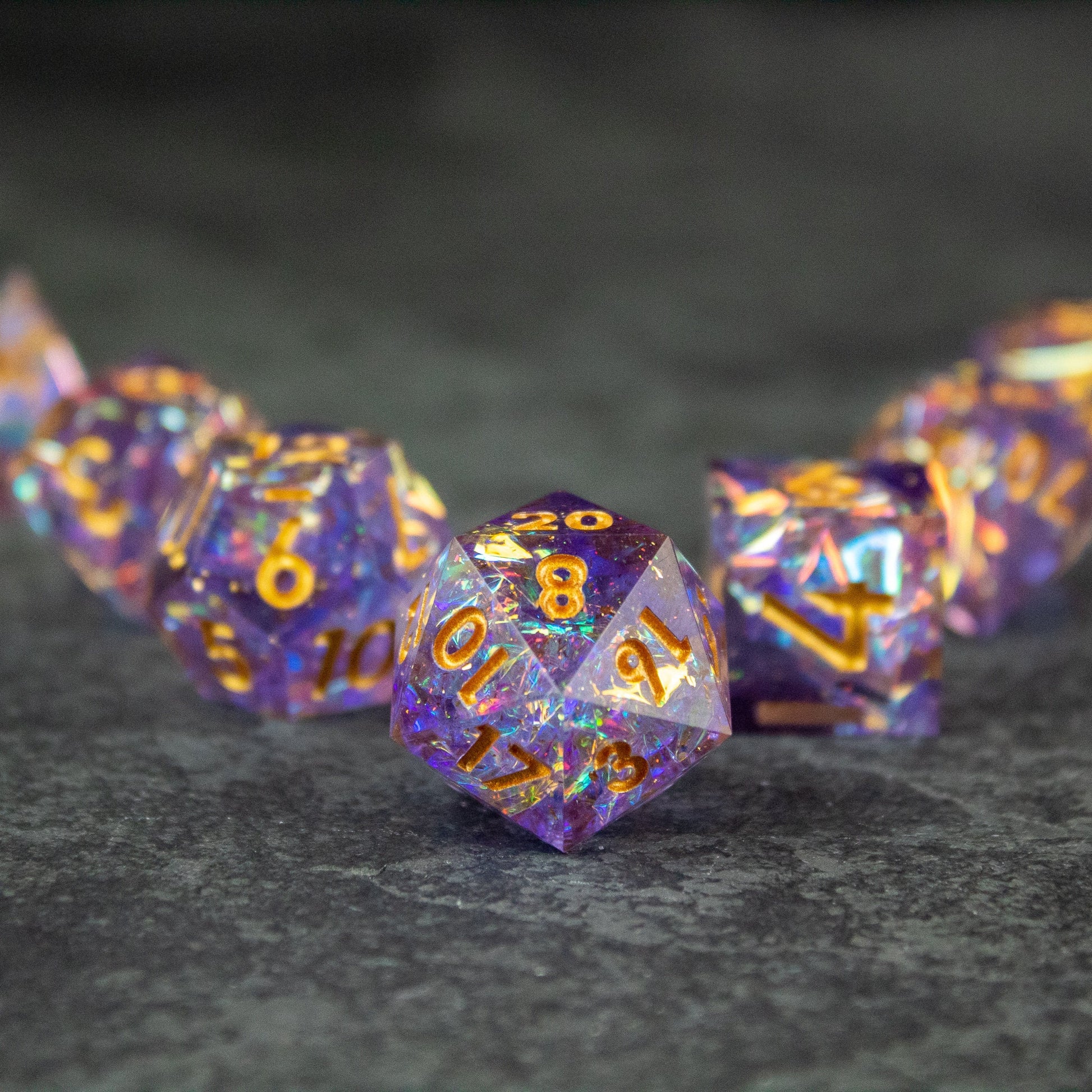 Feywild DnD Dice Set - Sharp Edge Dice for D&D - Purple and gold sharp-edged DnD dice set with glitter suspended inside.