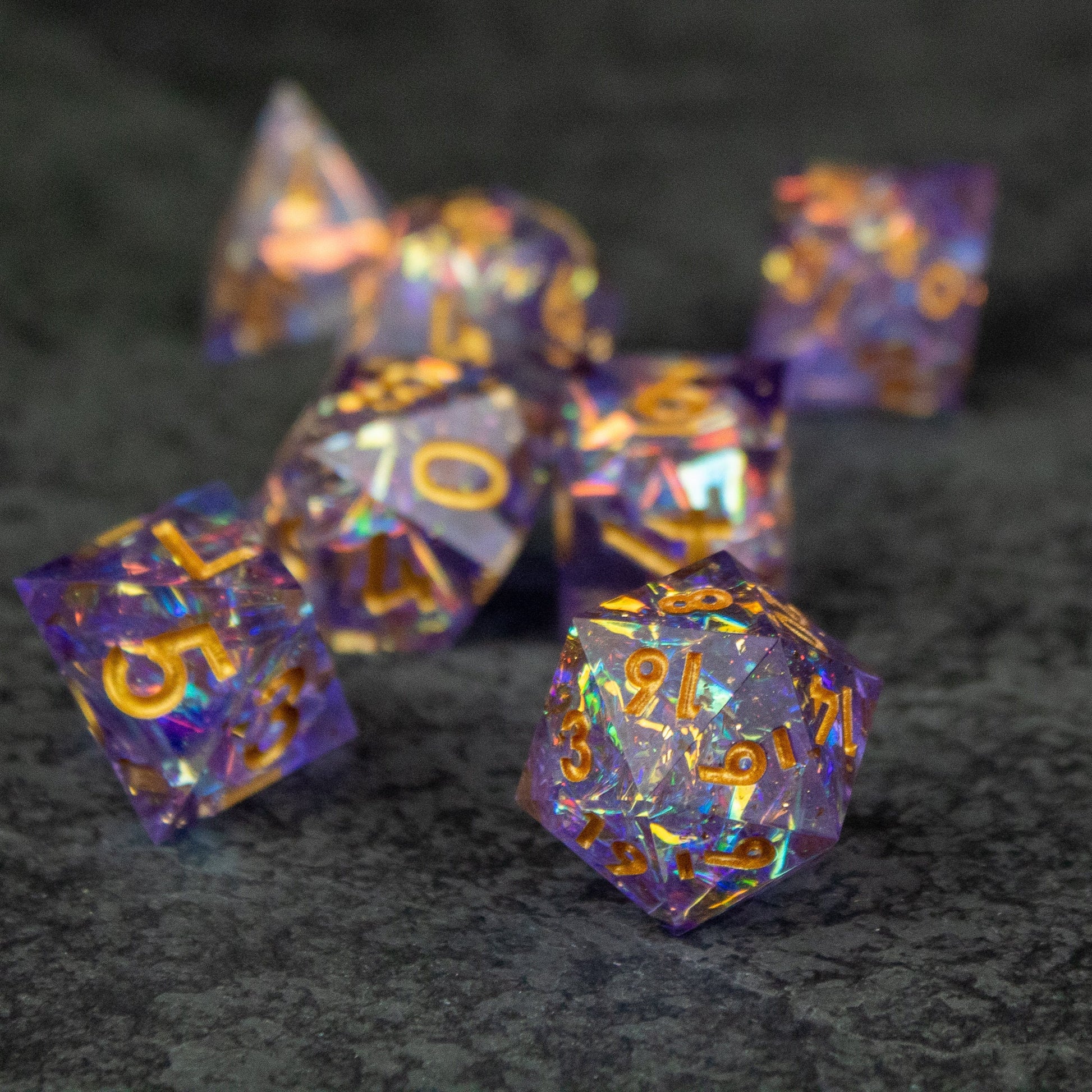 Feywild DnD Dice Set - Sharp Edge Dice for D&D - Purple and gold sharp-edged polyhedral dice set with intricate swirls for D&D gaming.